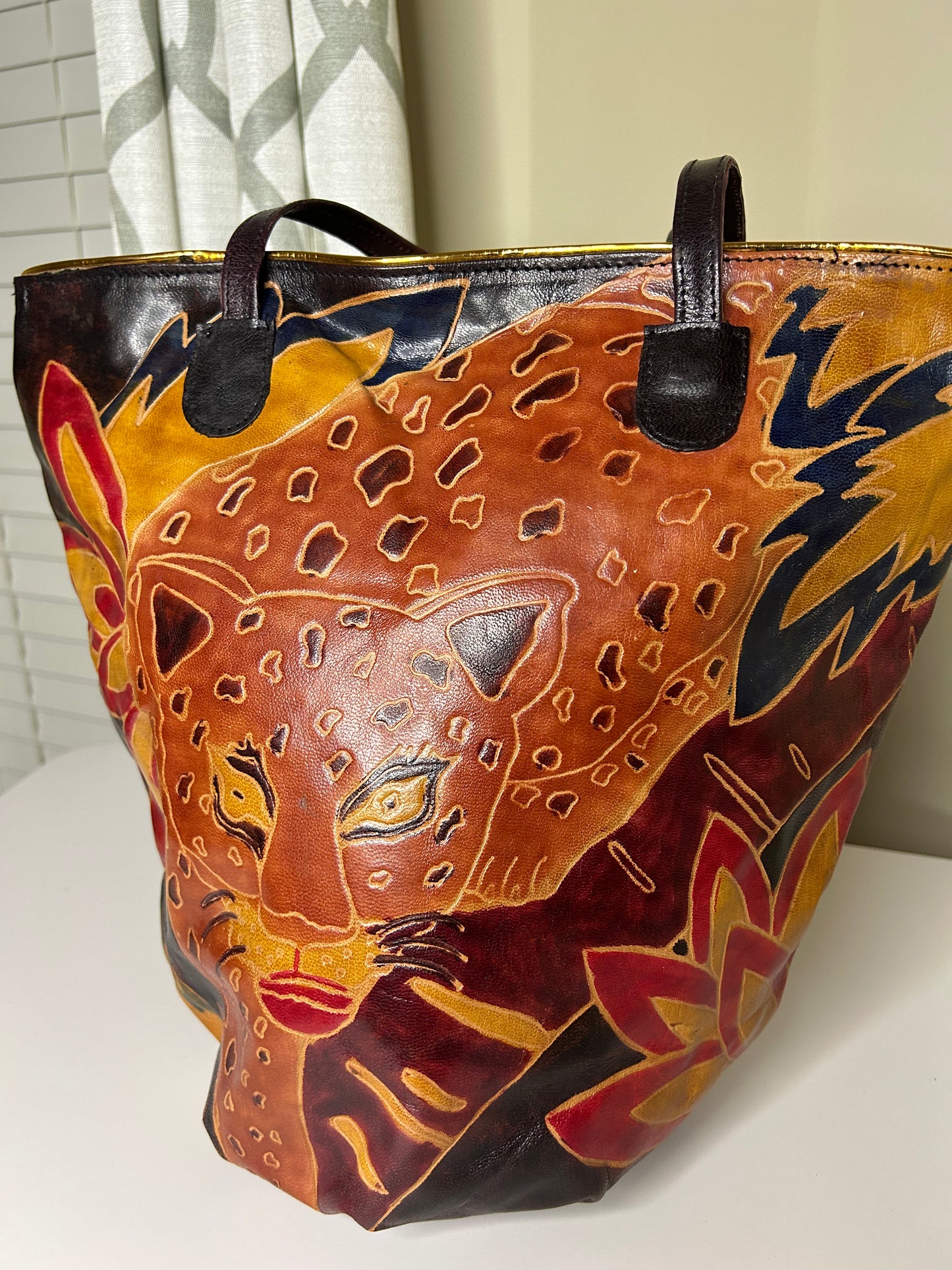 A person carefully examining a vintage handbag in a thrift store